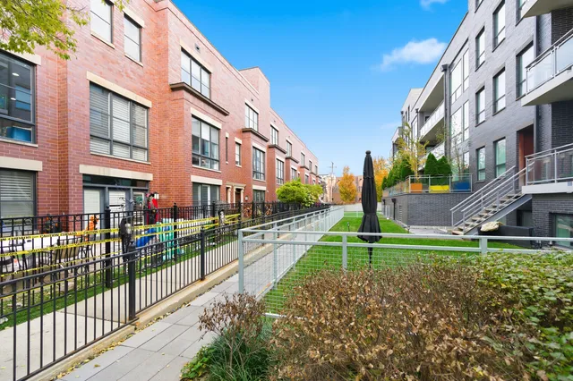 a view of a brick building next to a yard