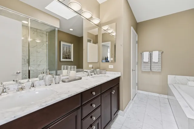 a bathroom with a tub shower and sink