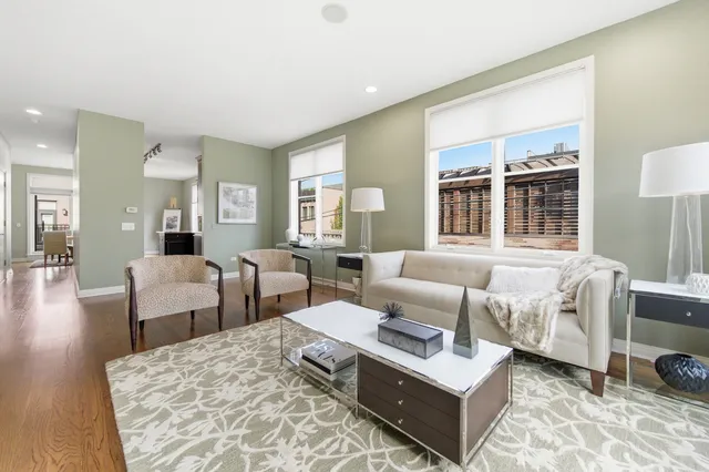 a living room with furniture a clock and a fireplace
