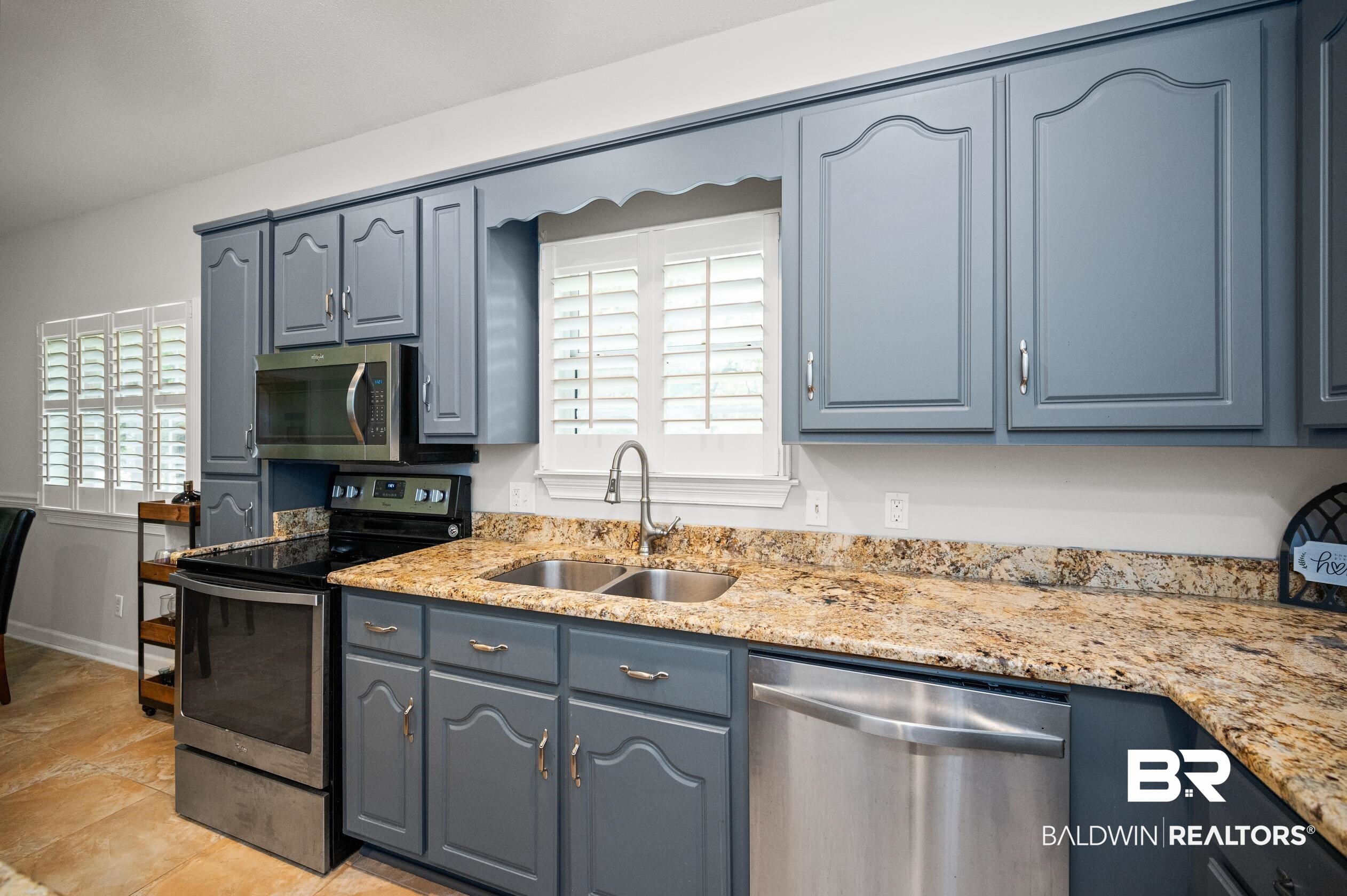 6638 Jackson Square Daphne, AL 36526 - Photo 14 of 62 Kitchen featuring stainless steel appliances, light stone countertops, and sink
