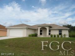 3918 38th Street Southwest Lehigh Acres, FL 33976 - Photo 1 of 1 a front view of a house with garden