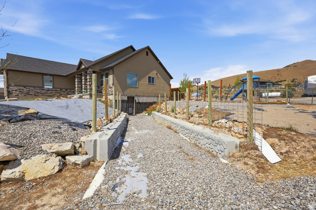 1588 West Rim Rock Drive Stockton, UT 84071 - Photo 49 of 61 Two-story residential structure featuring a stone veneer and stucco exterior