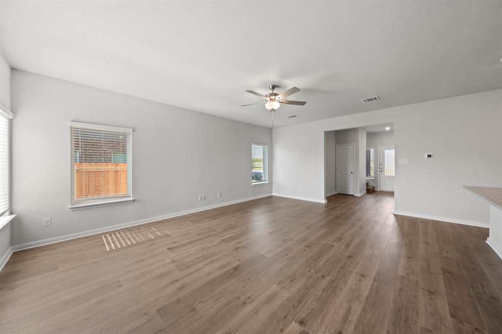 137 Magnolia Boulevard Hutchins, TX 75141 - Photo 3 of 8 a view of an empty room with a window and wooden floor