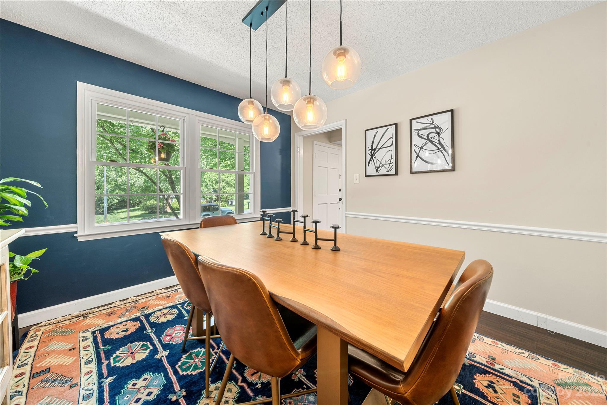 6433 Round Hill Road Charlotte, NC 28211 - Photo 15 of 33 a view of a dining room with furniture and a chandelier