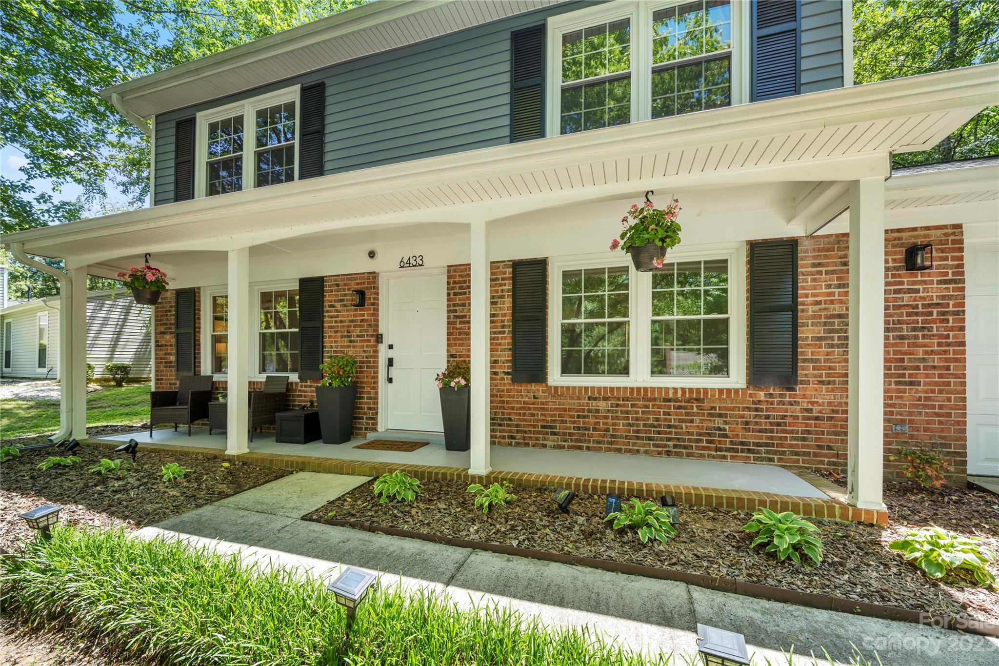 6433 Round Hill Road Charlotte, NC 28211 - Photo 2 of 33 a front view of a house with garden