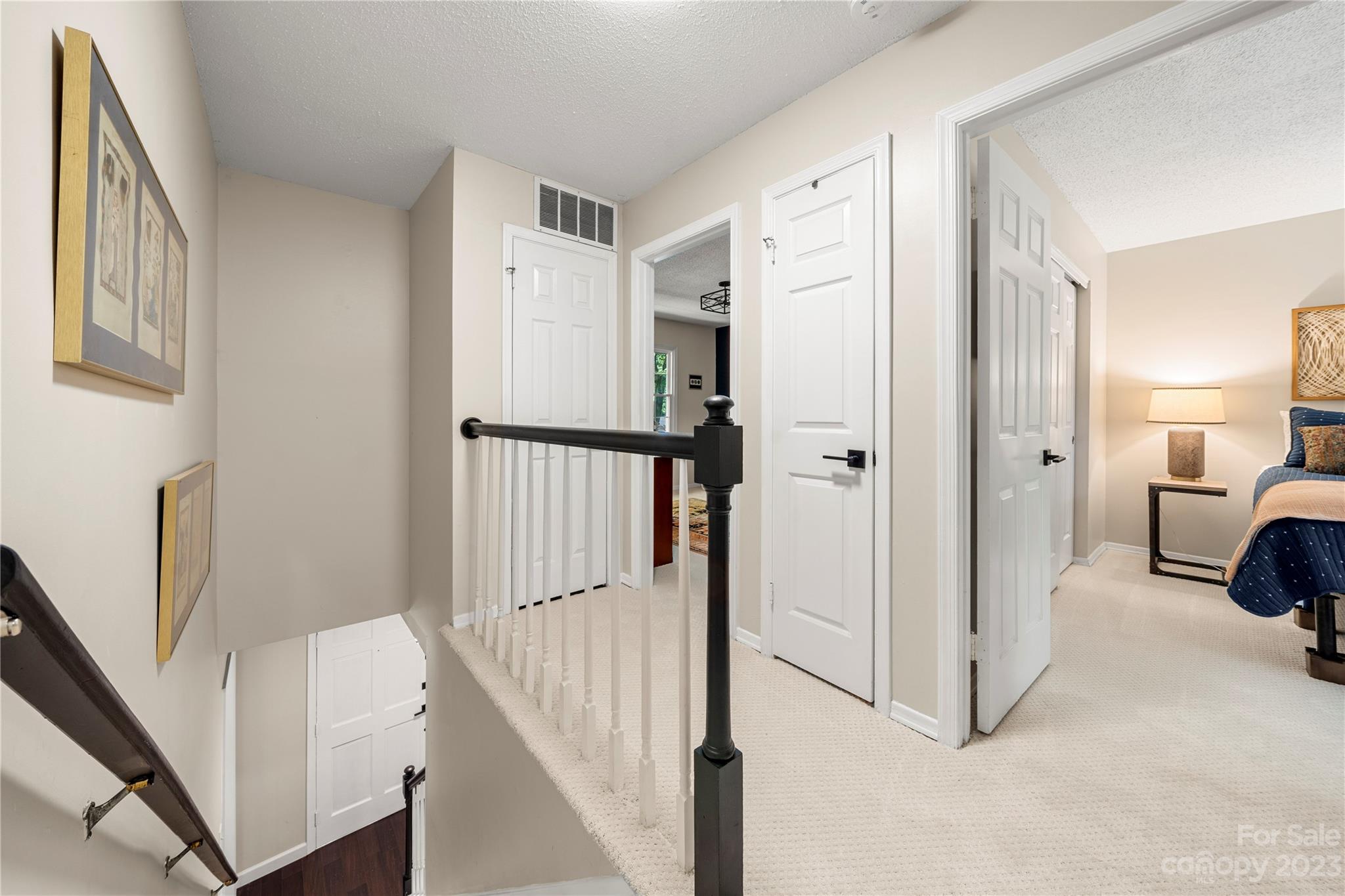 6433 Round Hill Road Charlotte, NC 28211 - Photo 28 of 33 a view of a hallway with white walls and stairs