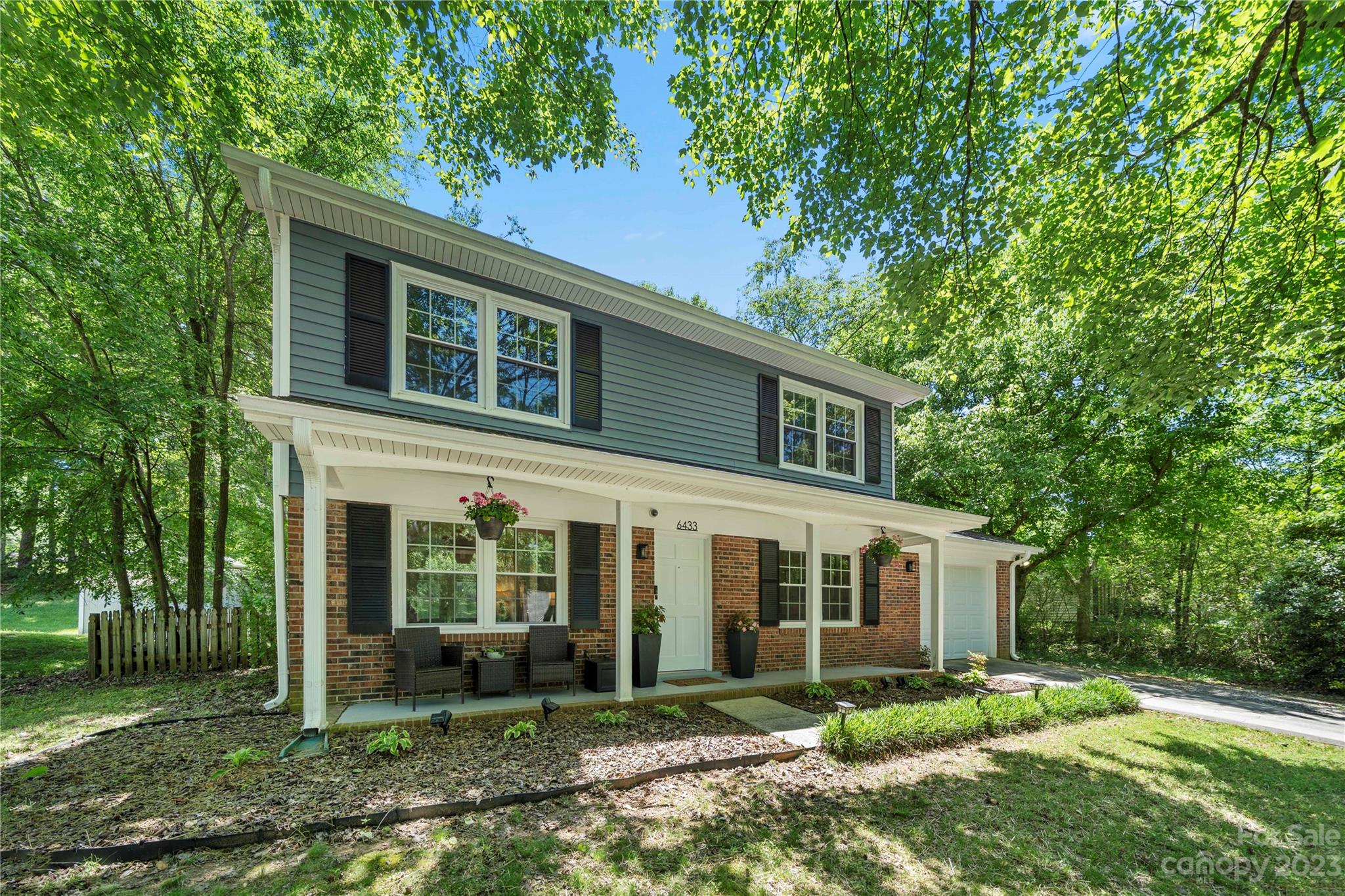 6433 Round Hill Road Charlotte, NC 28211 - Photo 3 of 33 a view of a yard in front of a house with plants and large tree