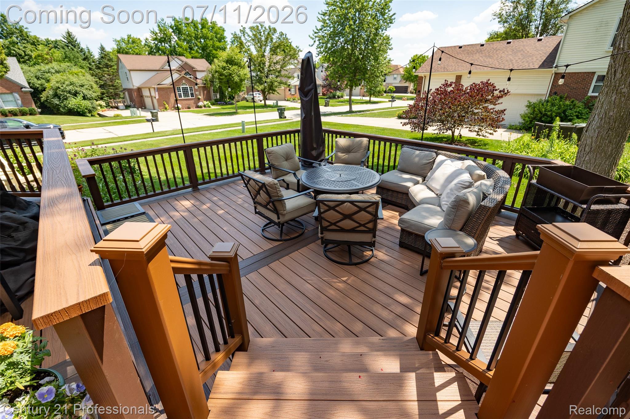 689 Woodfield Way Rochester, MI 48307 - Photo 5 of 61 Multi-level deck featuring composite decking, wood-finish railings, and integrated string lighting