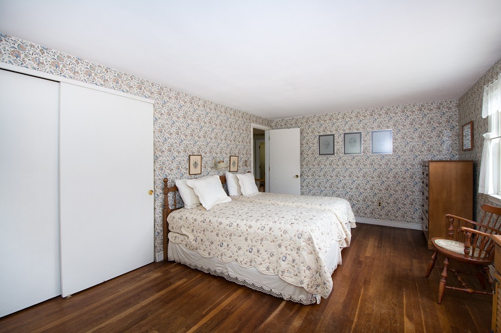 29 Hilltop Road Scituate, MA 02066 - Photo 14 of 22 a bedroom with a bed and wooden floor