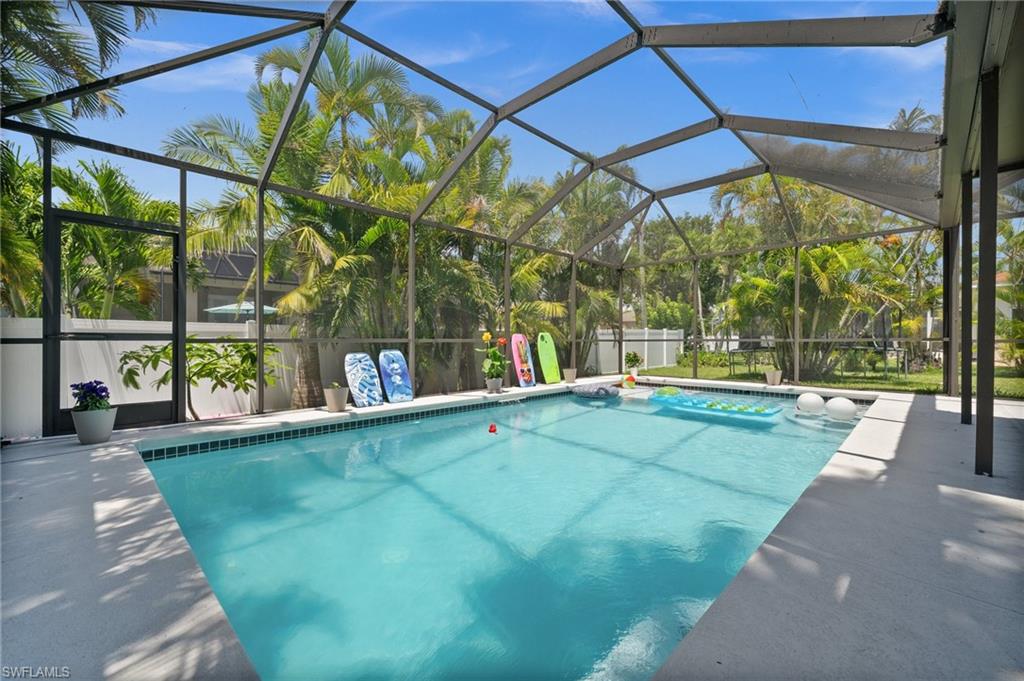 2017 Cape Coral Parkway West Cape Coral, FL 33914 - Photo 12 of 35 View of swimming pool featuring a patio area and glass enclosure