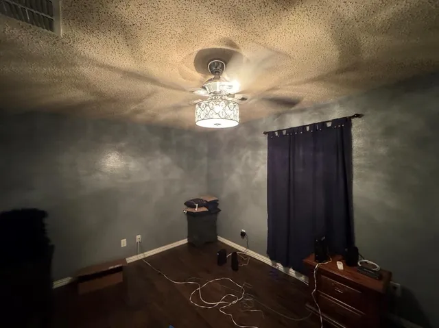 a bathroom with a mirror and a fan