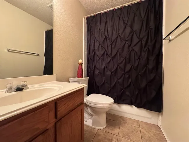 a bathroom with a sink toilet and mirror