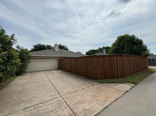 a view of basketball place with wooden fence