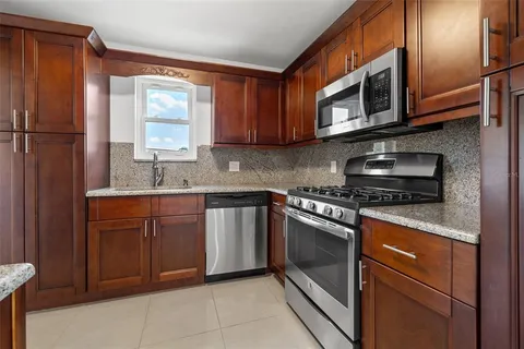 a kitchen with stainless steel appliances granite countertop a sink stove and microwave