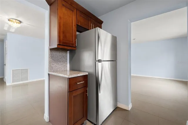 a kitchen with metallic refrigerator freezer and a dishwasher