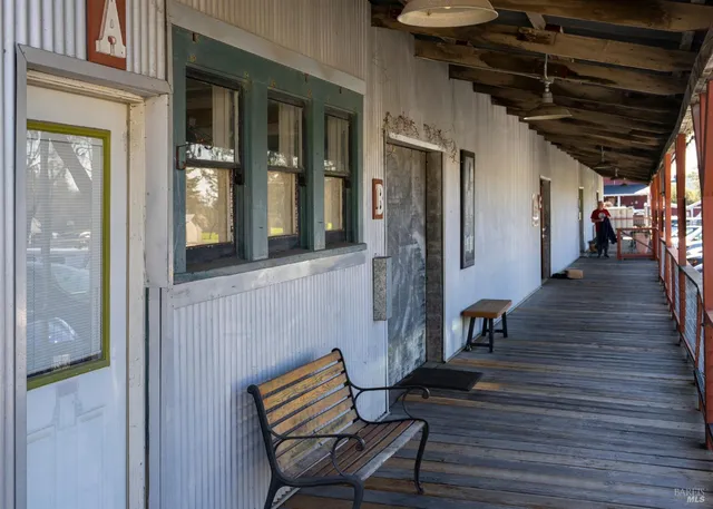 a view of a livingroom with wooden floor and furniture