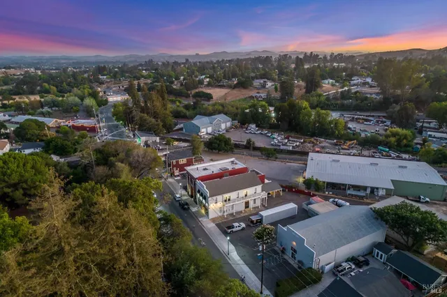 an aerial view of a houses with a city street