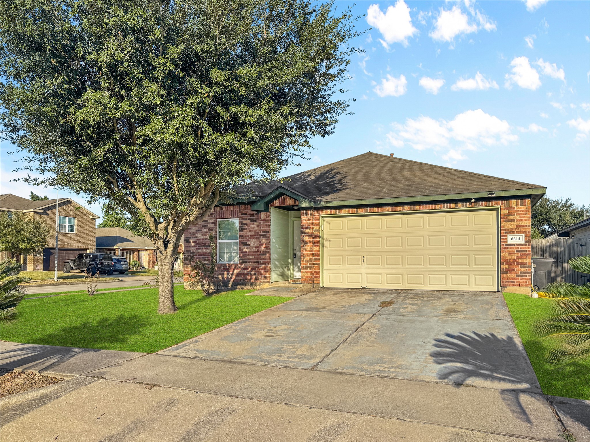 6614 Pine Tree Springs Houston, TX 77049 - Photo 13 of 14 a front view of a house with a garden and trees