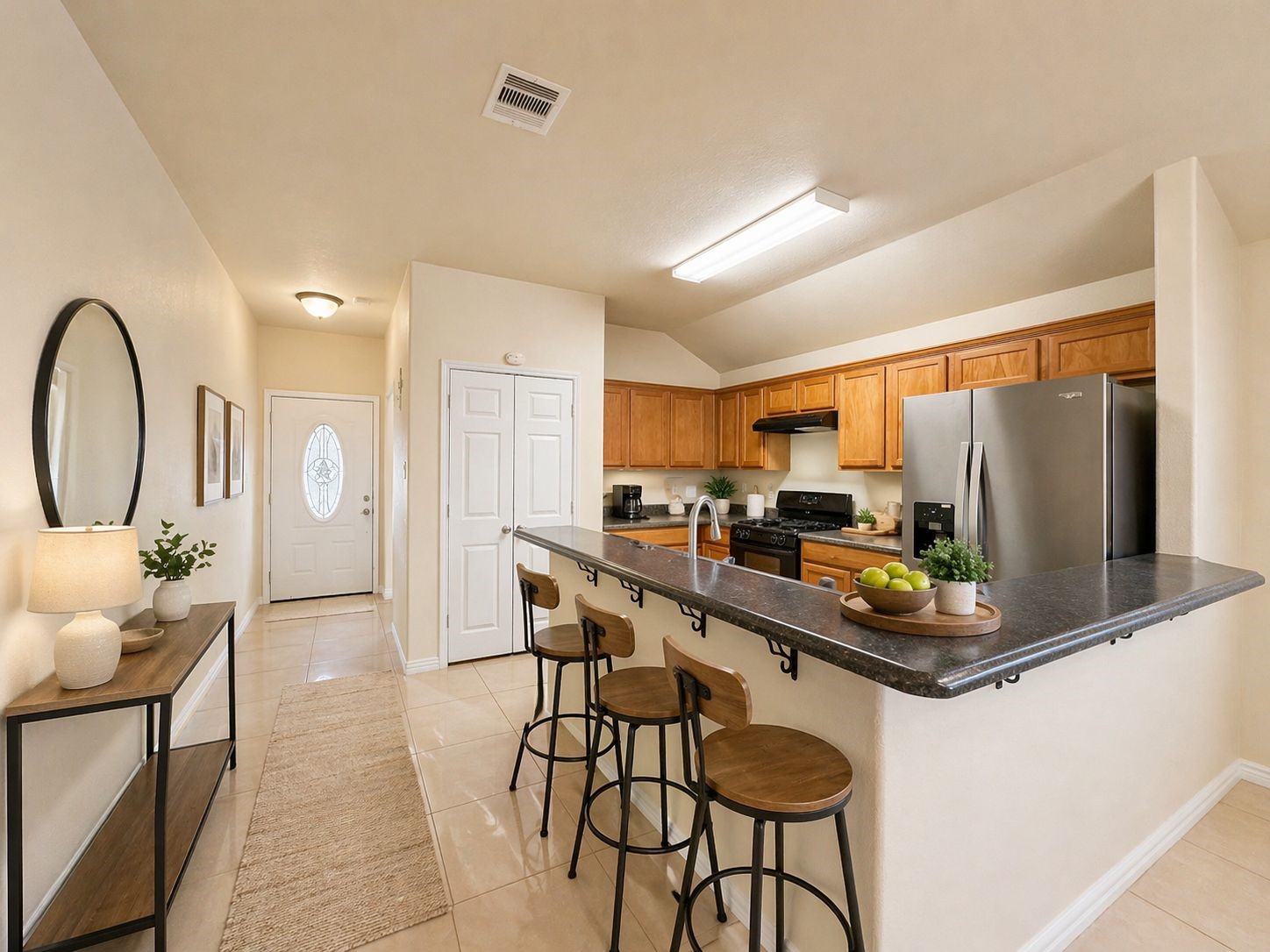 6614 Pine Tree Springs Houston, TX 77049 - Photo 4 of 14 a room with stainless steel appliances a dining table chairs and a refrigerator
