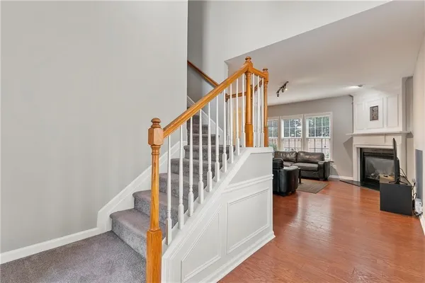 a view of entryway and hall with wooden floor
