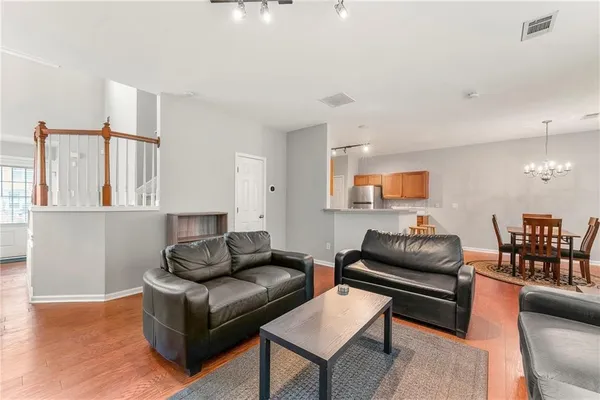a living room with furniture and wooden floor