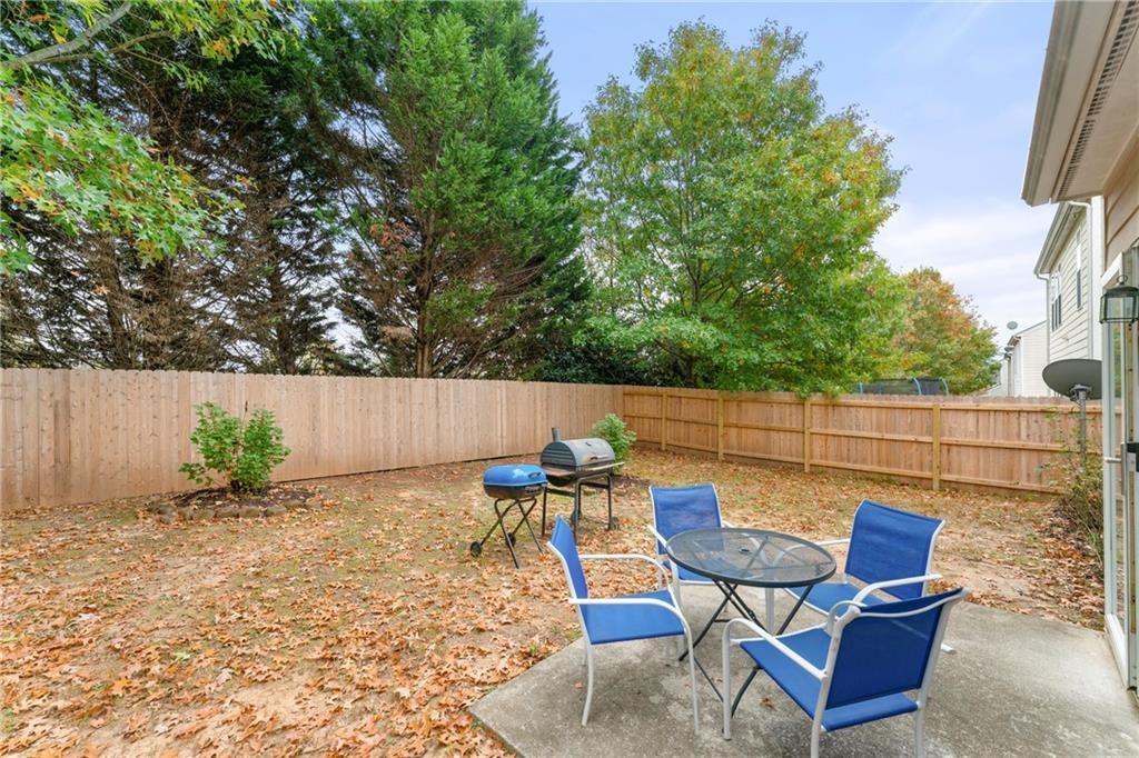 3218 Saville Street Southwest Atlanta, GA 30331 - Photo 6 of 12 a backyard of a house with table and chairs