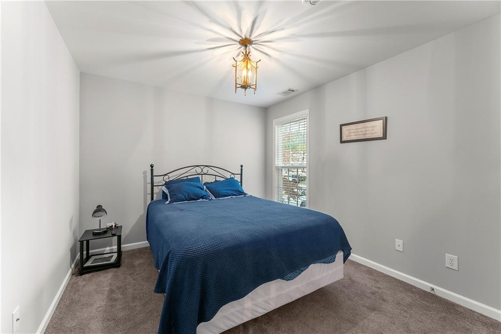 3218 Saville Street Southwest Atlanta, GA 30331 - Photo 9 of 12 a bedroom with a bed and a chandelier