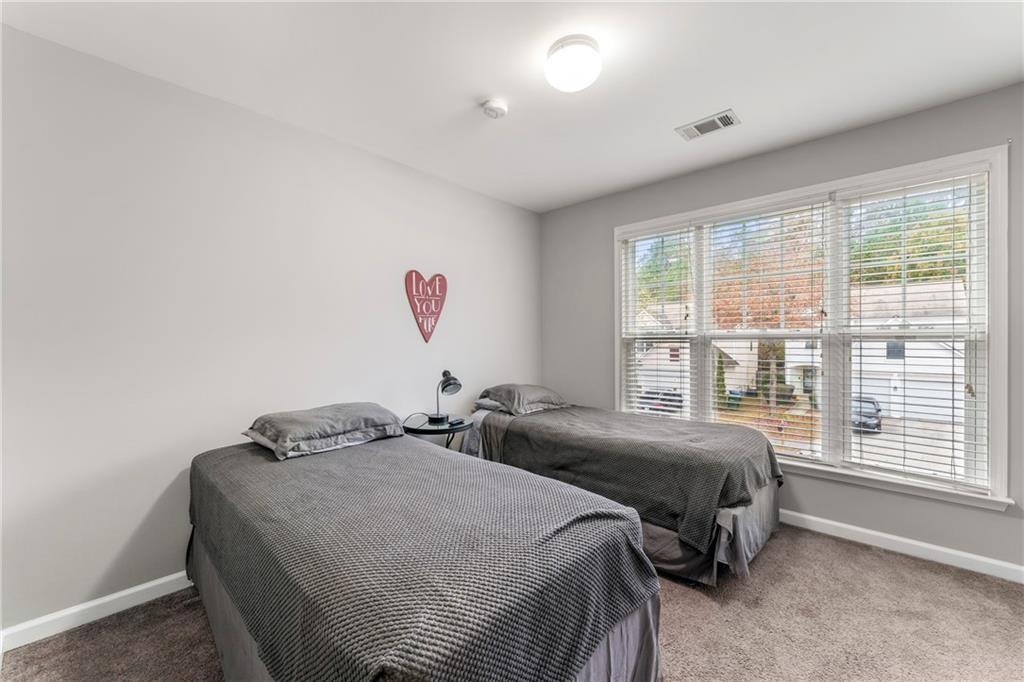 3218 Saville Street Southwest Atlanta, GA 30331 - Photo 10 of 12 a bedroom with two beds and a large window
