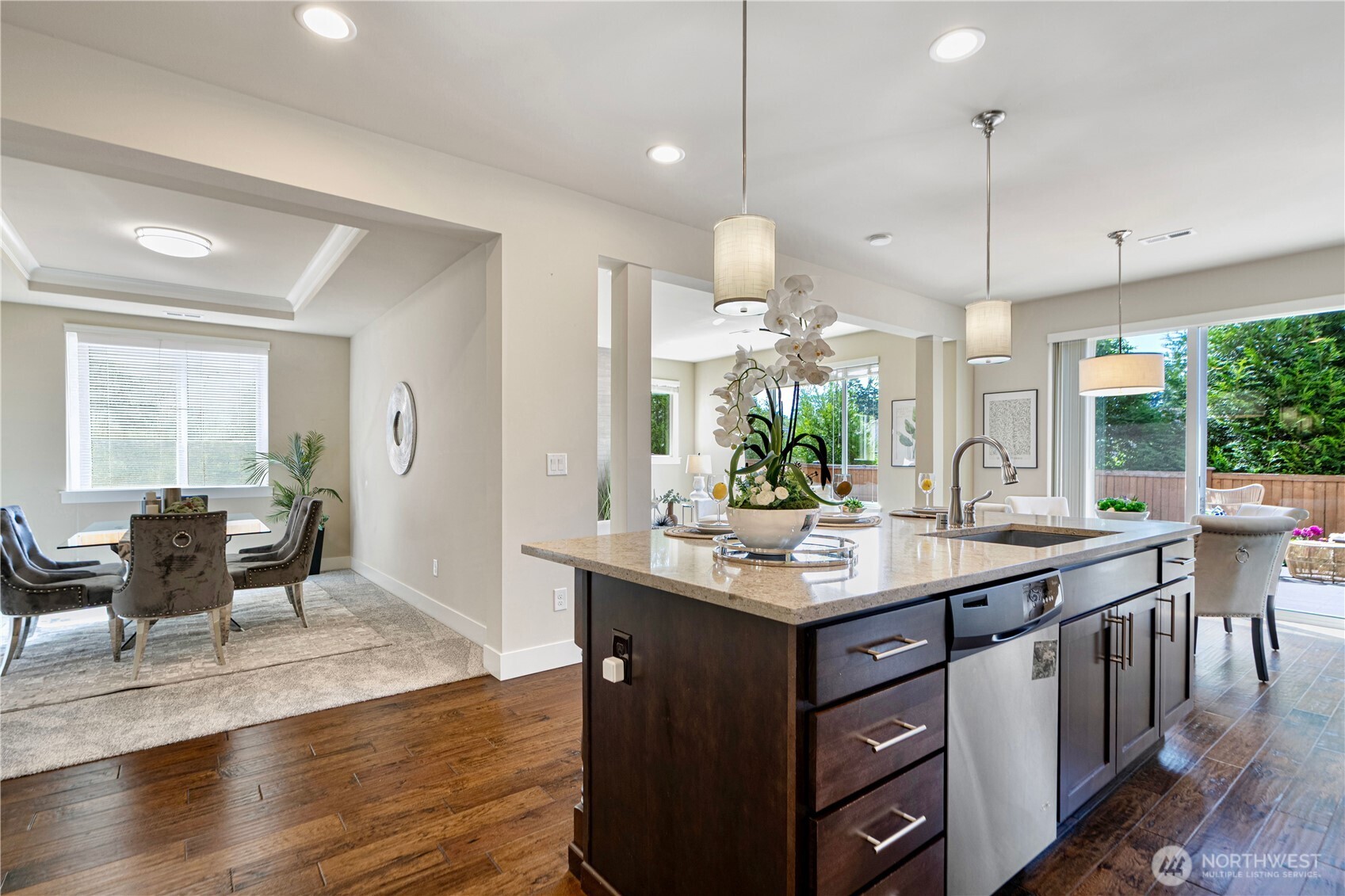 3718 226th Place Southeast Bothell, WA 98021 - Photo 4 of 30 a kitchen with kitchen island granite countertop a sink a counter space appliances and cabinets