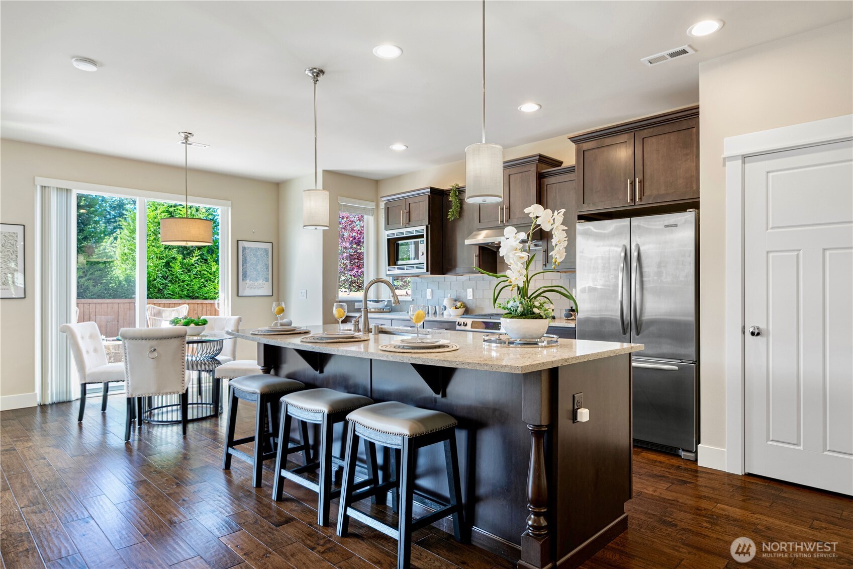 3718 226th Place Southeast Bothell, WA 98021 - Photo 8 of 30 a view of kitchen with stainless steel appliances granite countertop table chairs stove and refrigerator