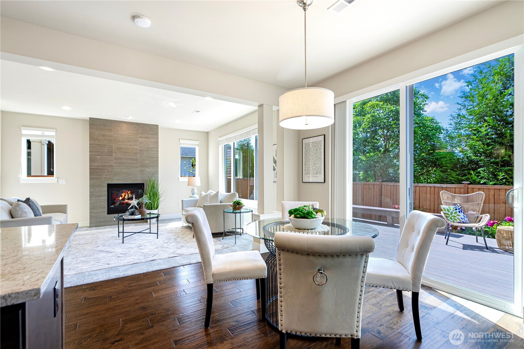 3718 226th Place Southeast Bothell, WA 98021 - Photo 9 of 30 a dining room with wooden floor a chandelier a glass table and chairs