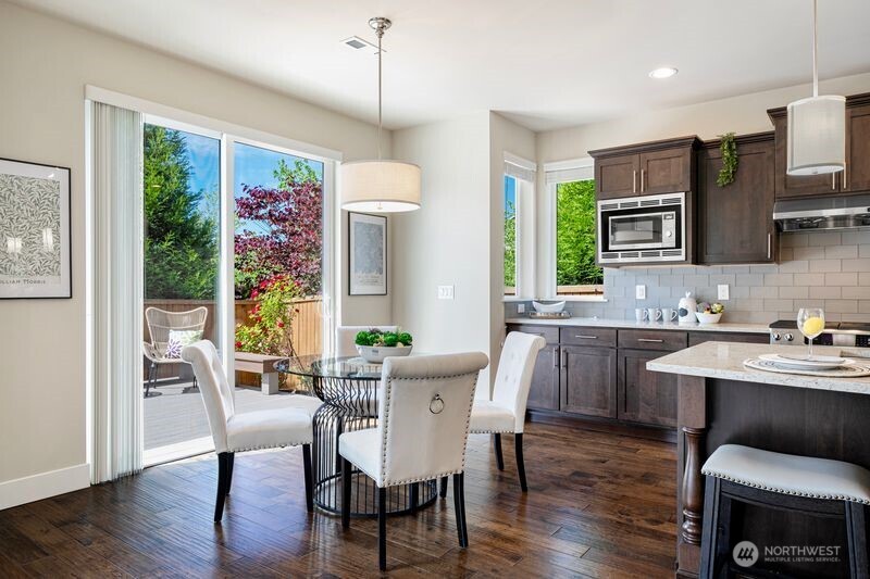 3718 226th Place Southeast Bothell, WA 98021 - Photo 10 of 30 a view of a dining room with furniture window and wooden floor