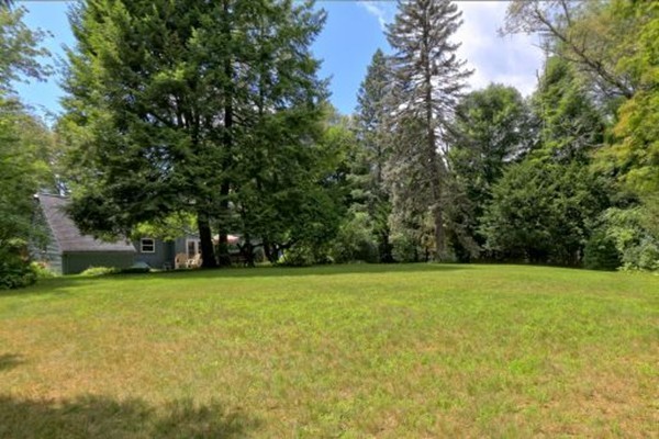 1 White Road Wayland, MA 01778 - Photo 5 of 22 a view of a green field with trees in the background