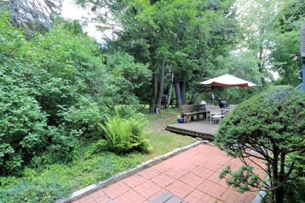 1 White Road Wayland, MA 01778 - Photo 8 of 22 a view of a patio with furniture and a garden