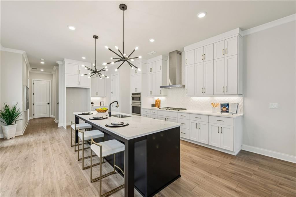 526 Pearl Street Cumming, GA 30040 - Photo 11 of 39 a kitchen with a table chairs sink and cabinets