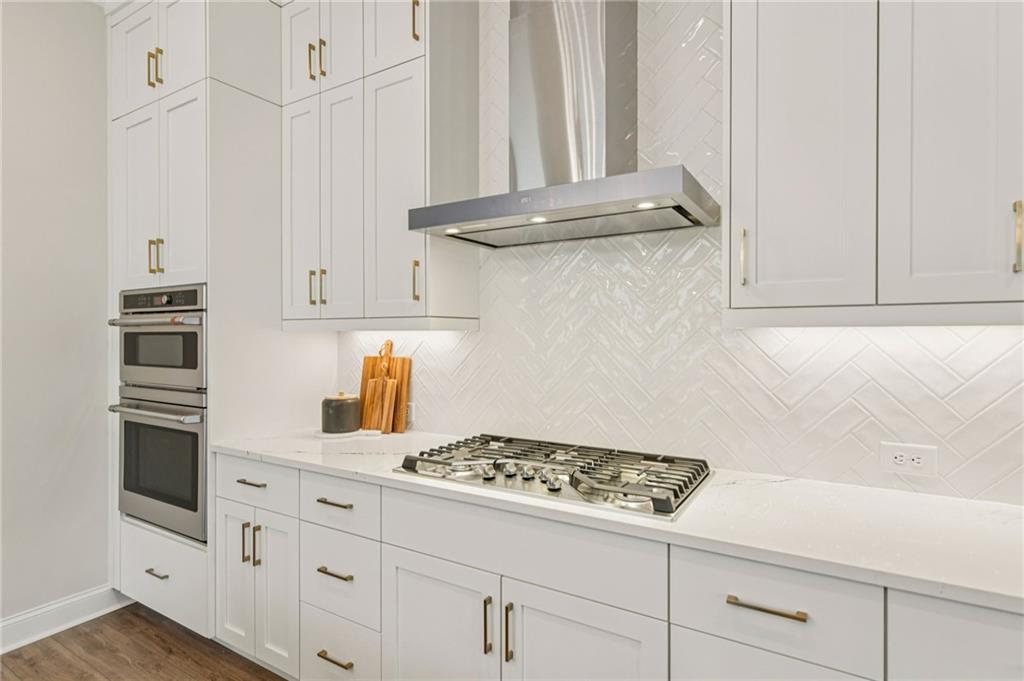 526 Pearl Street Cumming, GA 30040 - Photo 14 of 39 a kitchen with white cabinets and appliances
