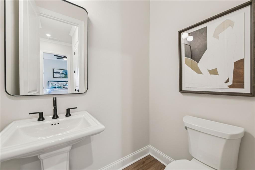 526 Pearl Street Cumming, GA 30040 - Photo 18 of 39 a bathroom with a toilet sink and mirror