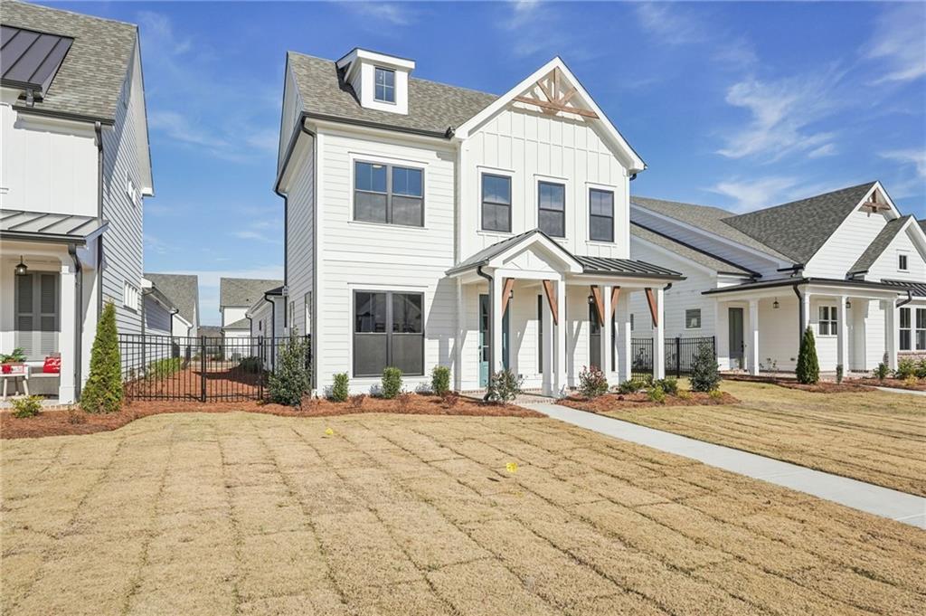 526 Pearl Street Cumming, GA 30040 - Photo 2 of 39 a front view of a building with a garden