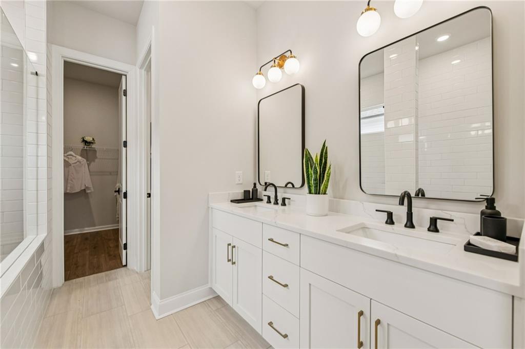 526 Pearl Street Cumming, GA 30040 - Photo 21 of 39 a bathroom with double sink and a mirror