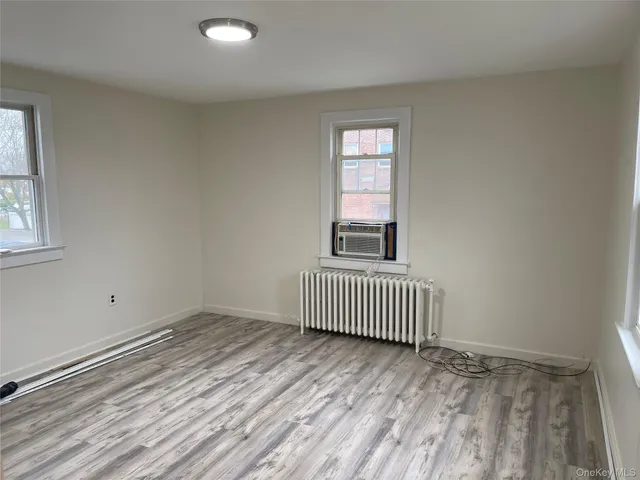 wooden floor and window in an empty room