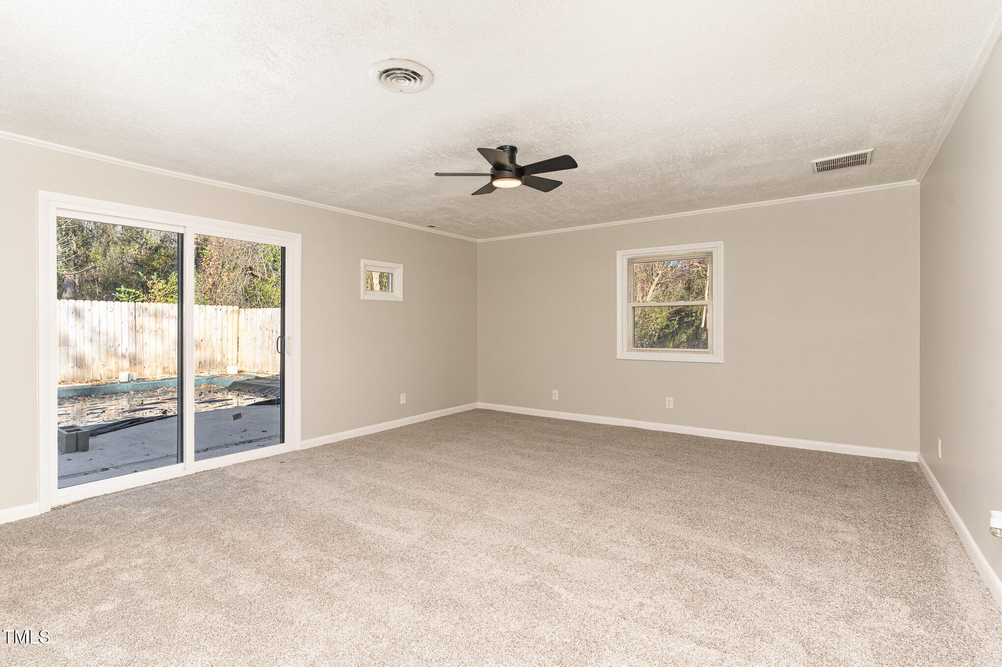 3015 Brinkley Drive Spring Lake, NC 28390 - Photo 14 of 28 an empty room with windows and chandelier fan