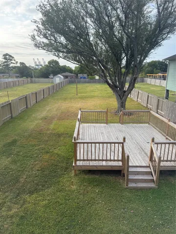 a view of house with deck and outdoor space