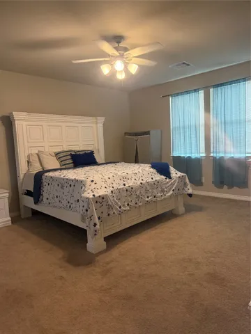 a bedroom with a bed and a television