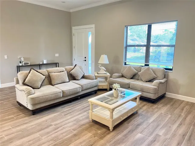 a living room with furniture and a large window