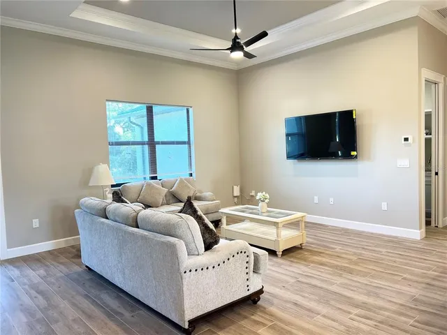 a living room with couches and a flat screen tv