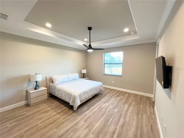 a bedroom with a bed and a flat screen tv
