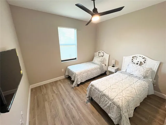 a bedroom with two beds and a table