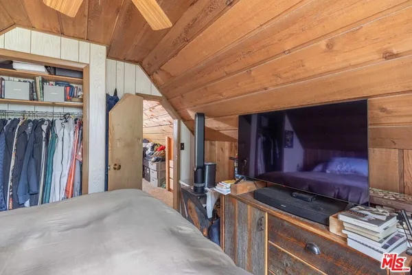 a bed sitting in a bedroom next to a window