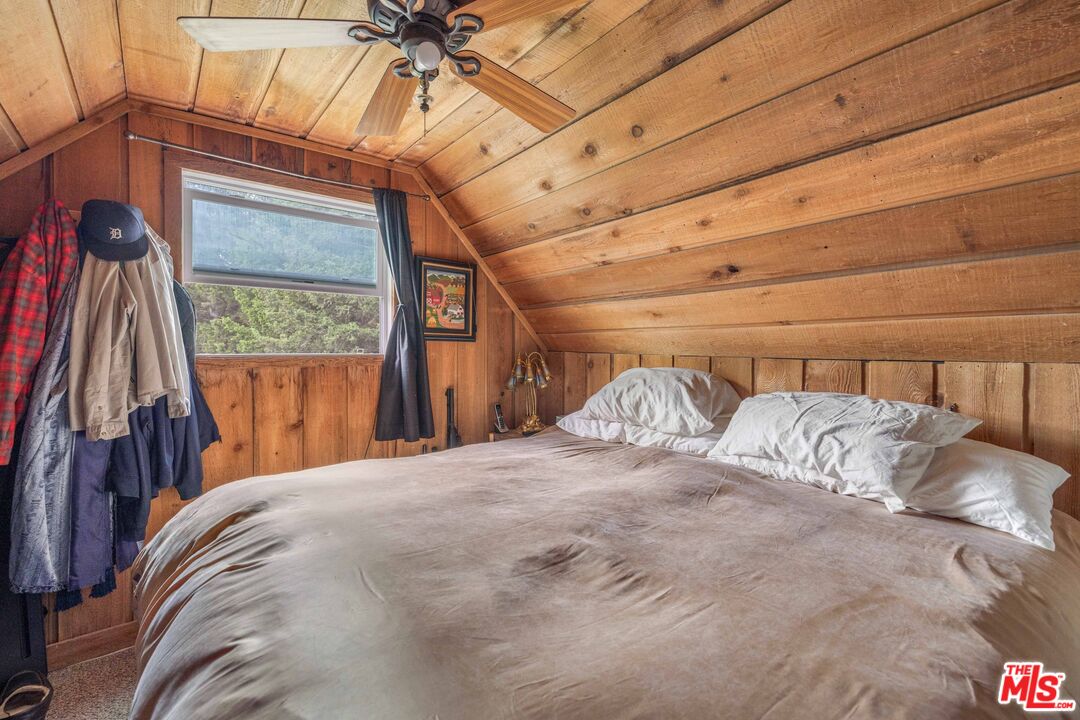 64050 Gallatin Road Gallatin Gateway, MT 59730 - Photo 14 of 55 a bed sitting in a bedroom next to a window