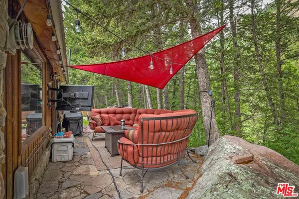 a backyard of a house with table and chairs